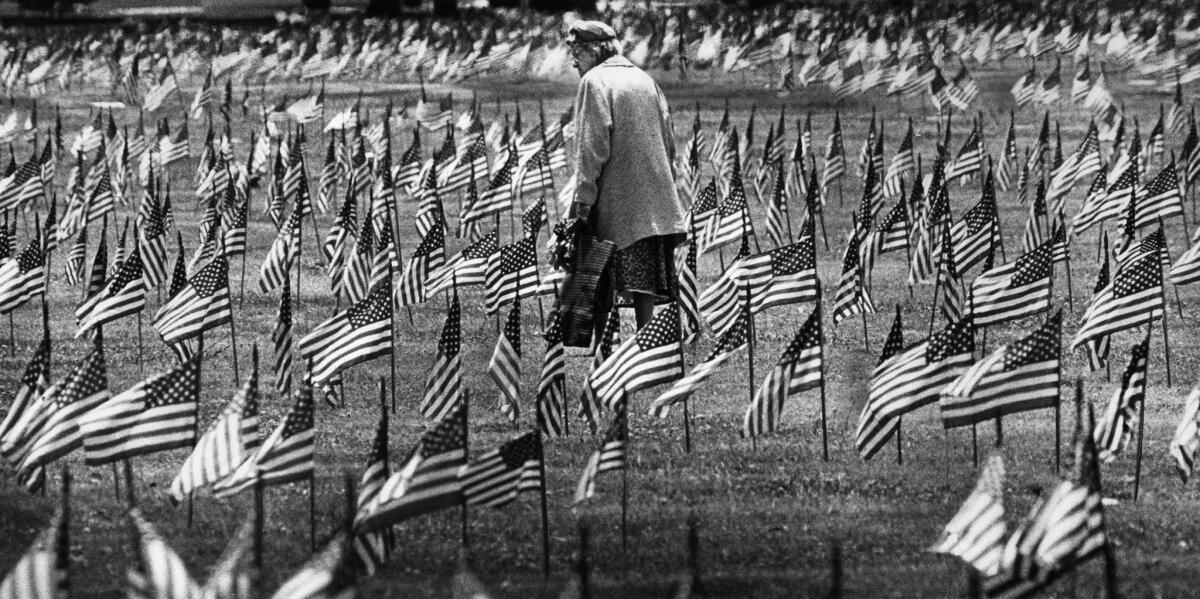 May 26, 1978: A woman carrying flowers searches for grave of loved one at Sawtelle Veterans Cemetery to decorate it for Memorial Day.