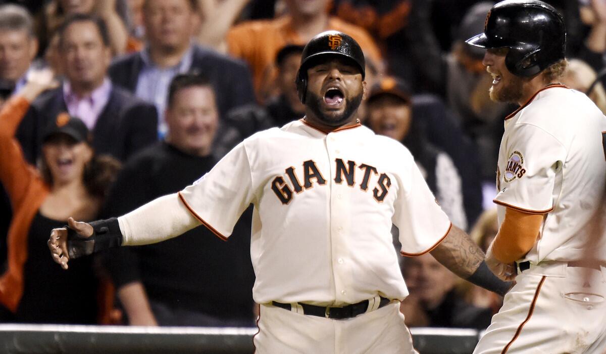 Giants third baseman Pablo Sandoval celebrates alongside teammate Hunter Pence after scoring in the eighth inning against the Royals in Game 5 of the World Series on Sunday night in San Fransisco.