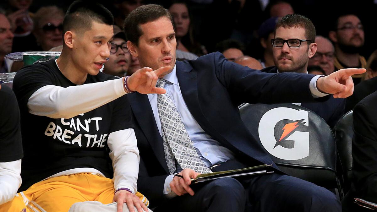 Lakers assistant coach Mark Madsen, right, speaks with guard Jeremy Lin before a game at Staples Center on Tuesday.