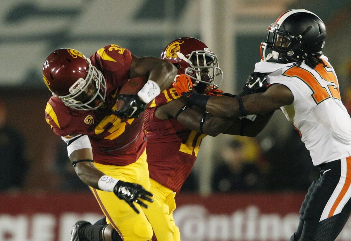 USC running back Javorius Allen gets a first down as receiver Ajene Harris puts a block on Oregon State cornerback Larry Scott in their game on Sept. 27.