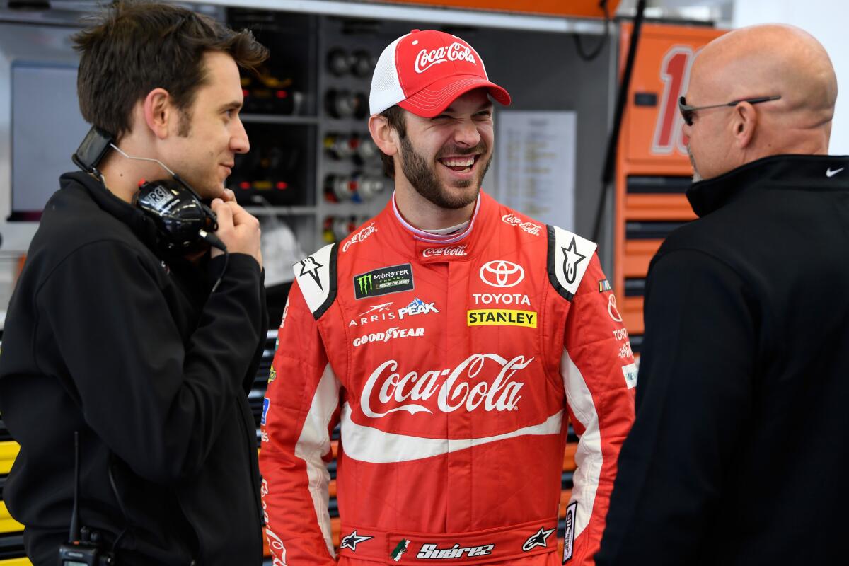 LAS VEGAS, NV - MARCH 03: Daniel Suarez, driver of the #19 Coca-Cola Toyota, talks to crew members during practice for the Monster Energy NASCAR Cup Series Pennzoil 400 presented by Jiffy Lube at Las Vegas Motor Speedway on March 3, 2018 in Las Vegas, Nevada.