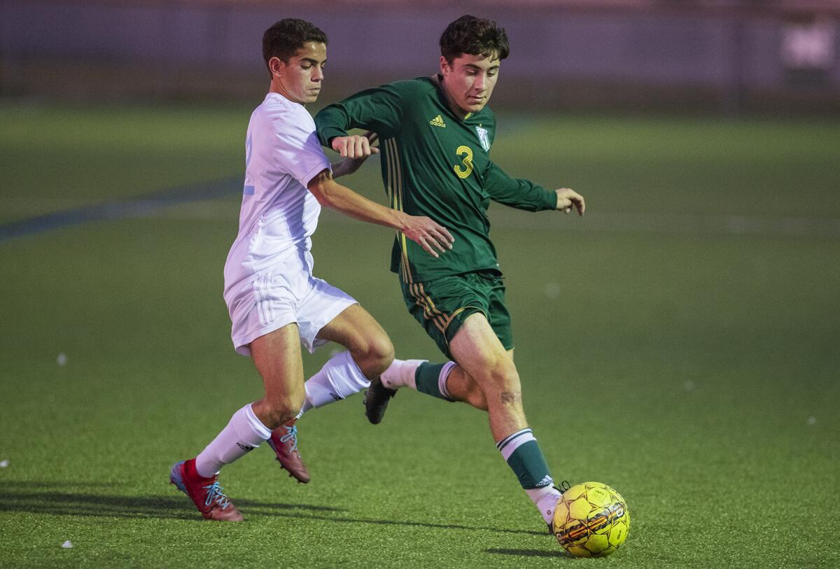 Corona del Mar's Hassan Selim and Edison's Padric Pigeon battle for a ball in the corner during a Surf League match on Friday.