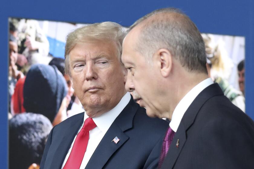 FILE - In this July 11, 2018 file photo, President Donald Trump, left, talks to Turkish President Recep Tayyip Erdogan as they tour the new NATO headquarters in Brussels, Belgium. Trumps decision to withdraw American troops from Syria was made hastily, without consulting his national security team or allies, and over the strong objections of virtually everyone involved in the fight against the Islamic State, according to U.S. officials. Trump stunned his Cabinet, lawmakers and much of the world with the move that triggered Defense Secretary Jim Mattis resignation by rejecting the advice of his top aides and agreeing to the pull-out in a phone call with Turkish President Recep Tayyip Erdogan last week, two officials briefed on the matter said. (Tatyana Zenkovich/pool photo via AP)