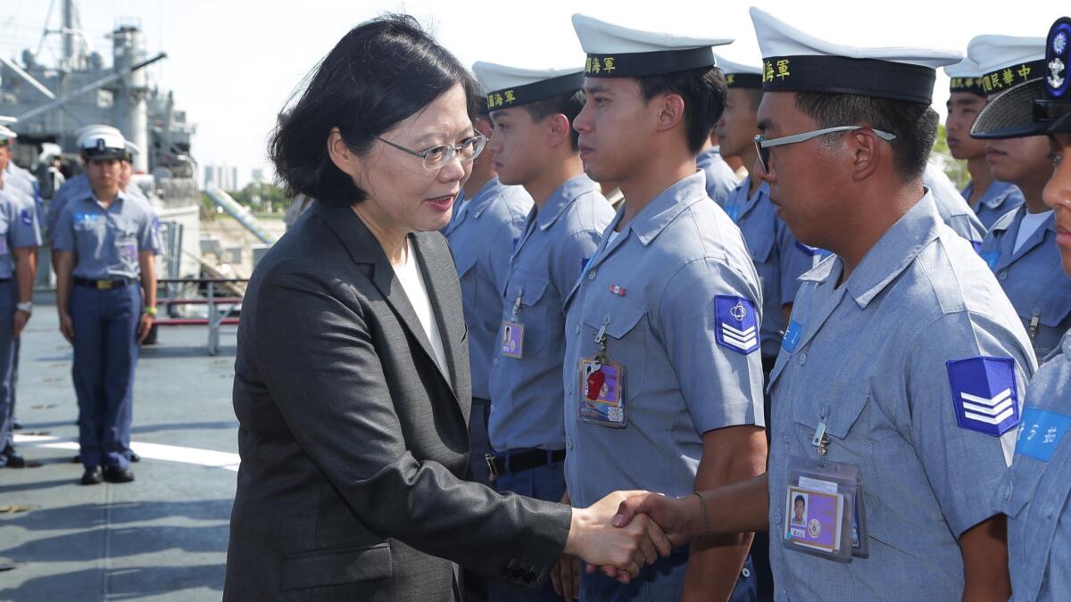 Taiwan's President Tsai Ing-wen shakes hands with crew members aboard a Taiwan navy ship before it sets out to patrol in the South China Sea.