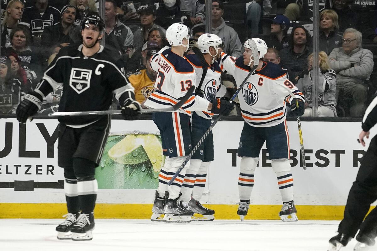 Kings captain Anze Kopitar skates off as Oilers left wing Evander Kane, second from right, celebrates his goal with teammates