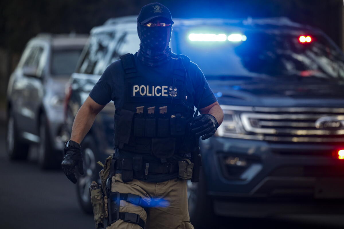 Masked Cop Despite rumors of massive immigration sweep in L.A., numbers don't add ...