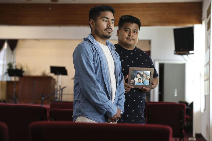 Left, Jesimiel and Daniel Rivera stand inside the New Assurance Baptist Church.