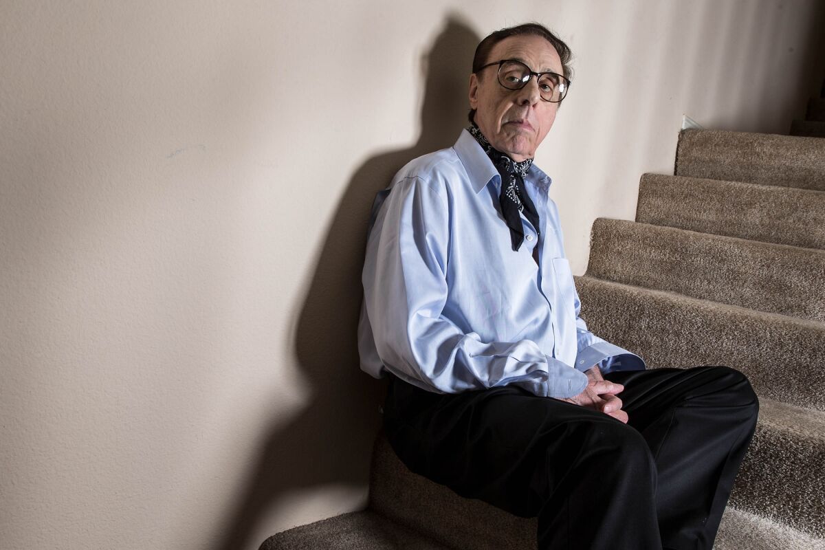  Film director Peter Bogdanovich sits on a staircase.
