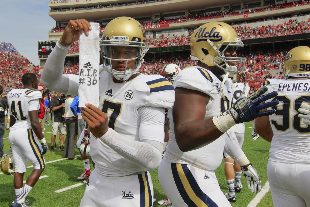 UCLA quarterback pays homage to teammate Nick Pasquale, who was killed earlier this week after being hit by a vehicle, following the Bruins' 41-21 comeback victory over Nebraska on Saturday.