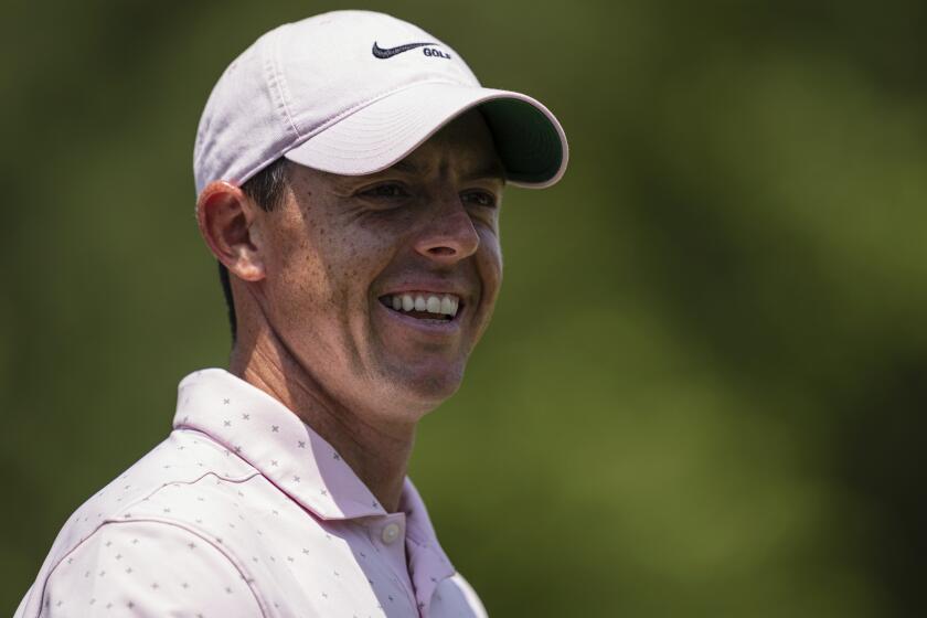 Rory McIlroy smiles after his putt on the third hole during the fourth round of the Wells Fargo Championship.