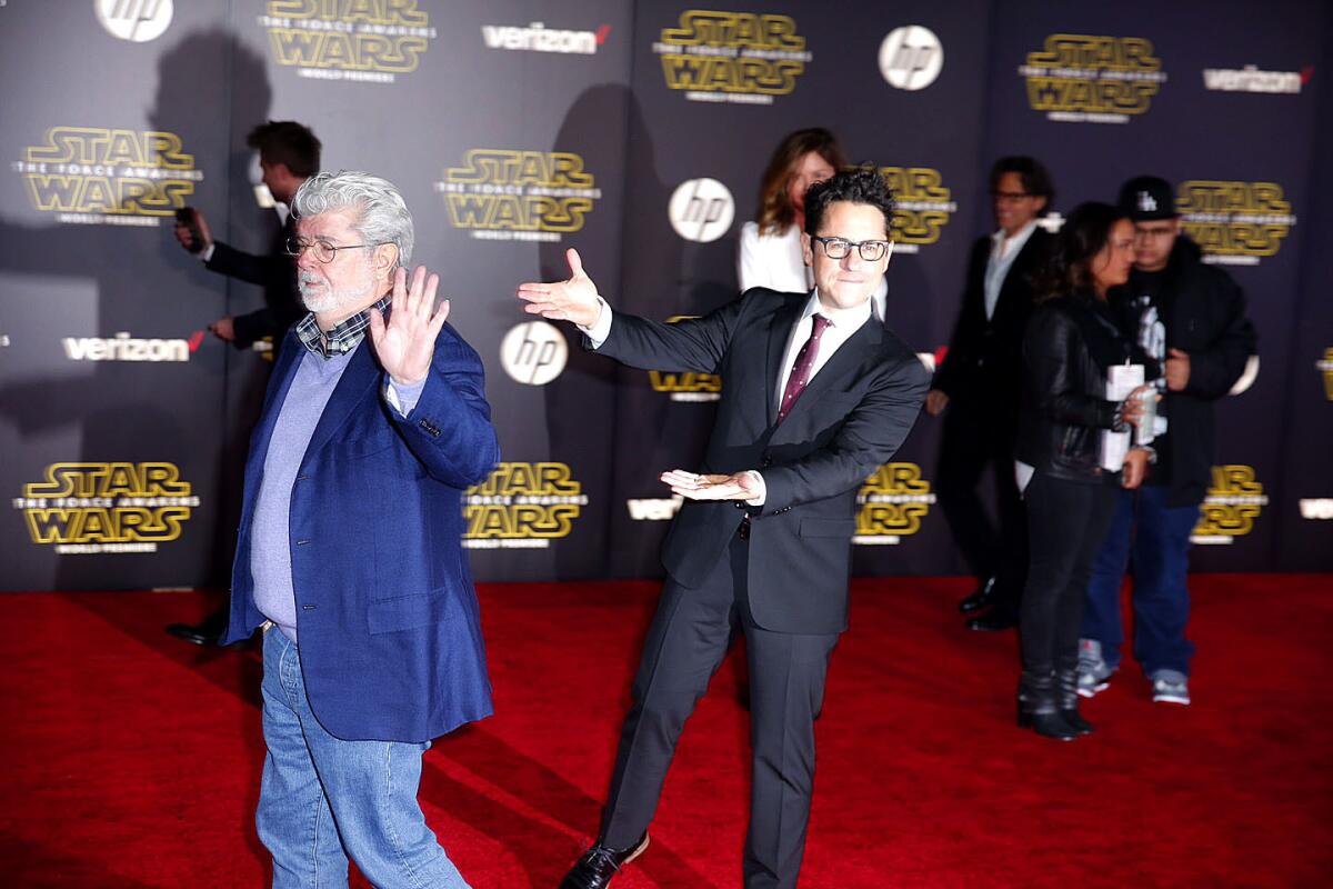 J.J. Abrams acknowledges George Lucas as he continues down the carpet toward the Hollywood premiere of "Star Wars: The Force Awakens."