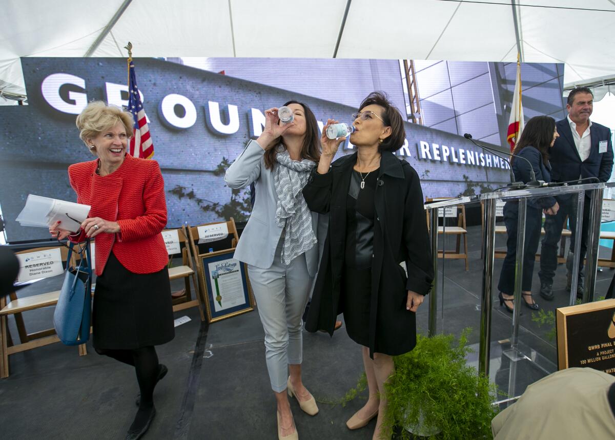 Cottie Petrie-Norris, center, and Young Kim drink treated water Friday as Diane Dixon looks on.