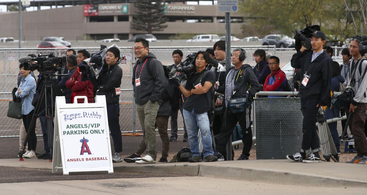 Members of the media await the arrival of the Angels' Shohei Ohtani at Tempe Diablo Stadium in 2018.