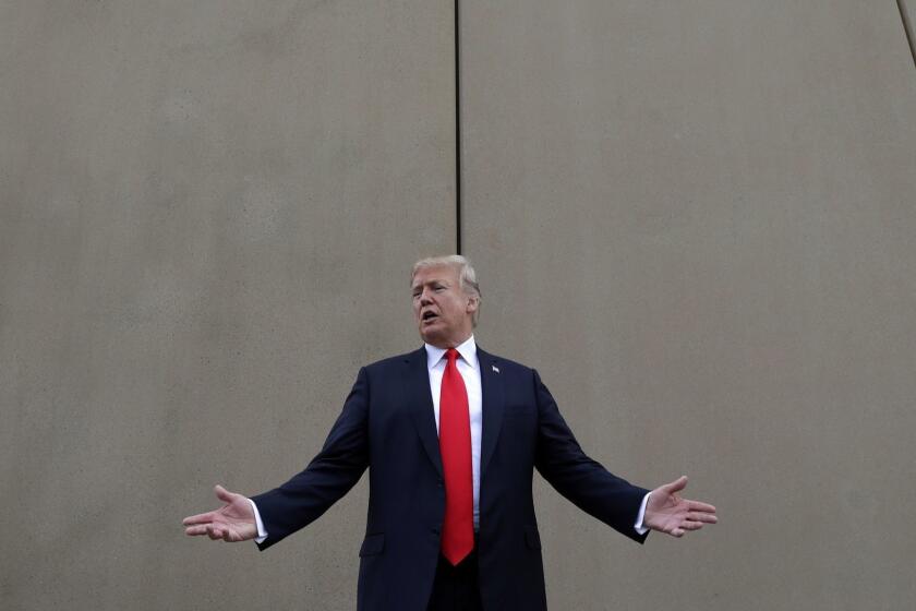 In this March 13, 2018 photo, President Donald Trump speaks during a tour as he reviews border wall prototypes in San Diego. Trump hails the start of his long-sought southern border wall, proudly tweeting photos of the âWALL!â Actually, no new work got underway. The photos show the continuation of an old project to replace two miles of existing barrier. (AP Photo/Evan Vucci)