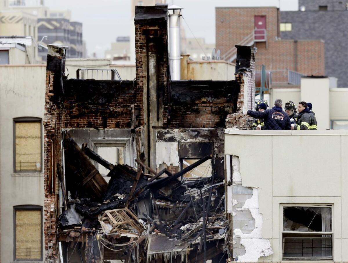 Work crews look over the remains of two buildings destroyed in a gas explosion in Manhattan that killed eight people.