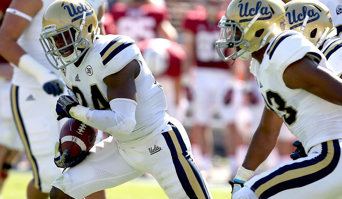 UCLA cornerback Ishmael Adams celebrates with teammates after intercepting a pass against Stanford last season.