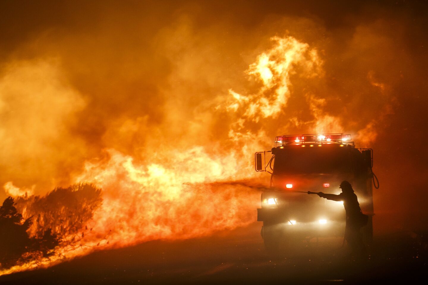 GOLETA, CALIF. -- THURSDAY, JUNE 16, 2016: Firefighters combat the front lines of the Sherpa Fire to avoid it from moving onto Highway 101, along Calle Real road, in Goleta, Calif., on June 16, 2016. (Marcus Yam / Los Angeles Times)