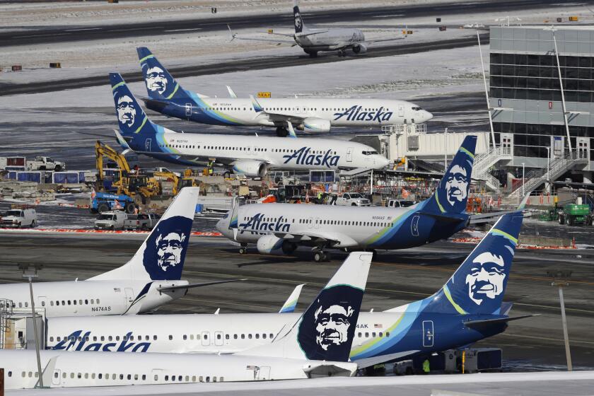 FILE - In this Feb. 5, 2019, file photo, Alaska Airlines planes are parked at a gate area at Seattle-Tacoma International Airport in Seattle. Alaska Airlines said over 300 employees among the company's workforce in Anchorage may lose their jobs on Oct. 1, 2020. The company said the Anchorage layoffs are part of company-wide job cuts because of the economic fallout from the coronavirus pandemic, Alaska Public Media reported Tuesday, Aug. 4. (AP Photo/Ted S. Warren, File)