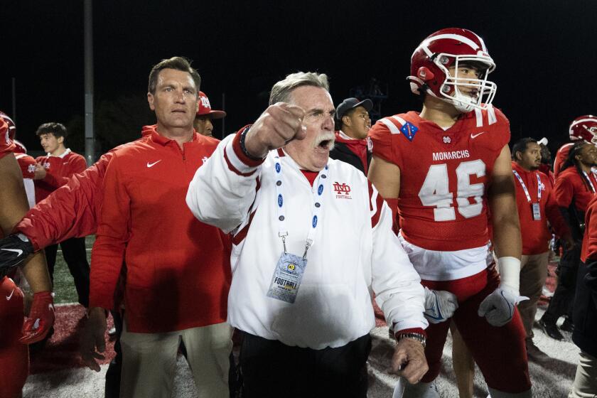 Long Beach, CA - November 26: Mater Dei head coach Bruce Rollinson reacts after the team defeating Servite.