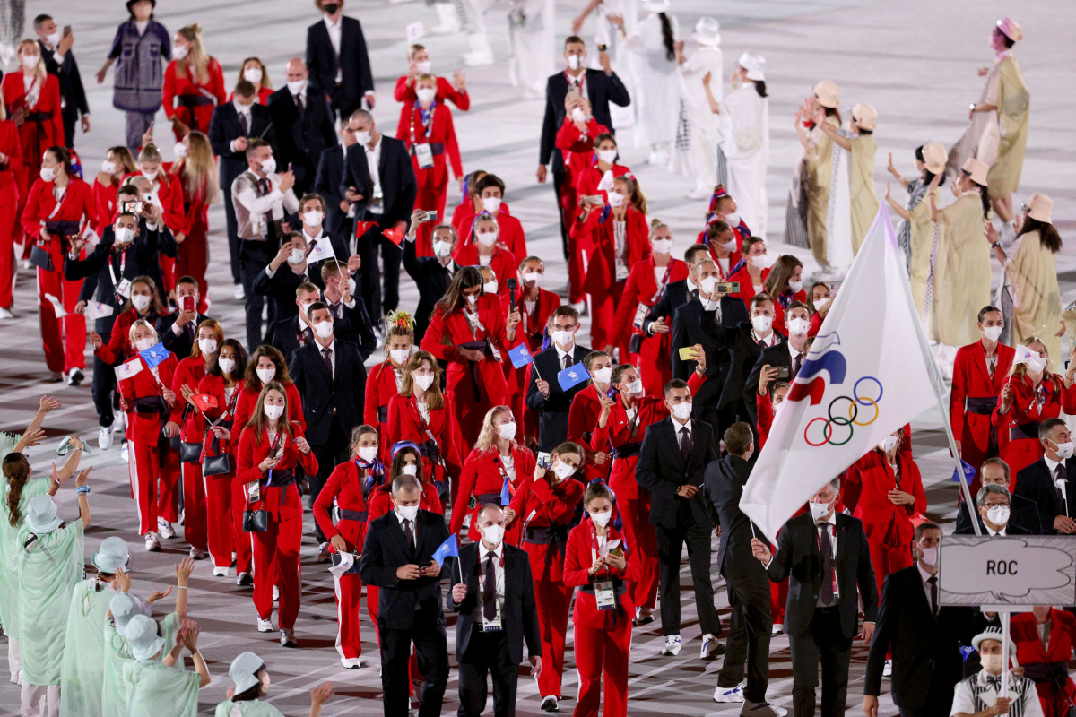 Flag bearers Sofya Velikaya and Maxim Mikhaylov of ROC lead the team during the Olympic opening ceremony.