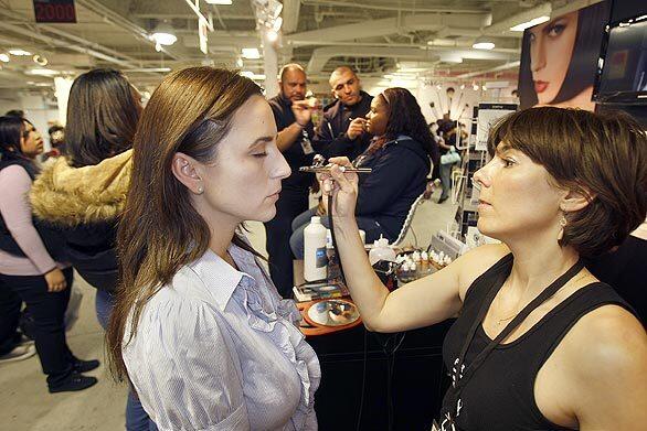 By Steffie Nelson Clearly there is no stereotypical makeup industry pro, because the debut last week of the Makeup Show L.A. at the California Market Center drew cosmetics buffs of every color, stripe and packaging. There were rocker chicks with purple hair and matching lips, tanned and lithe blonds in black, older gentlemen in suits, skinny boys with eyeliner and artfully contoured cheekbones, drag queens, fashionistas, and suburban moms; all streaming into the penthouse space to test new products, sit in on seminars and maybe score some cheap sable brushes. Pictured: Makeup artist Laura Reynolds airbrushes cosmetics on Noelle LoPorto on March 16 at the Makeup Show L.A.
