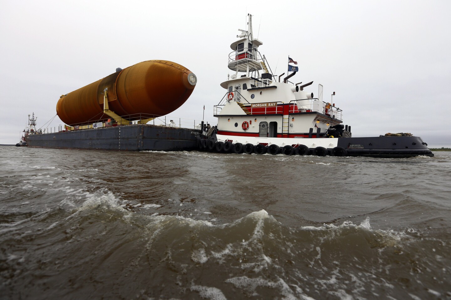 A view of the rust-colored behemoth external tank, dubbed ET-94, is shown leaving its longtime home at NASA's Michoud Assembly Facility in New Orleans.