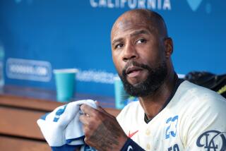 LOS ANGELES, CALIFORNIA-Dodgers Jason Heyward watches form the dugout against the Angels at Dodgers Stadium Saturday. (Wally Skalij/Los Angeles Times)