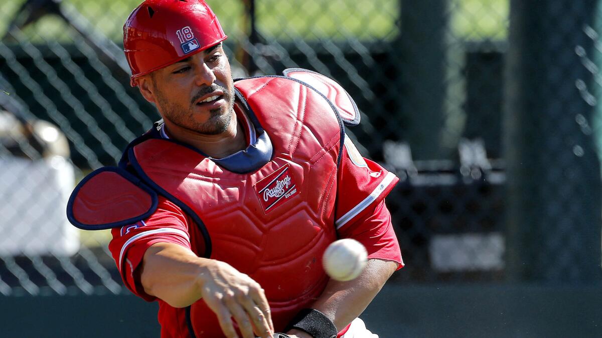 Angels catcher Geovany Soto, who is making a throw to first base during a spring training drill last month, had a three-run home run against the Dodgers on Friday.