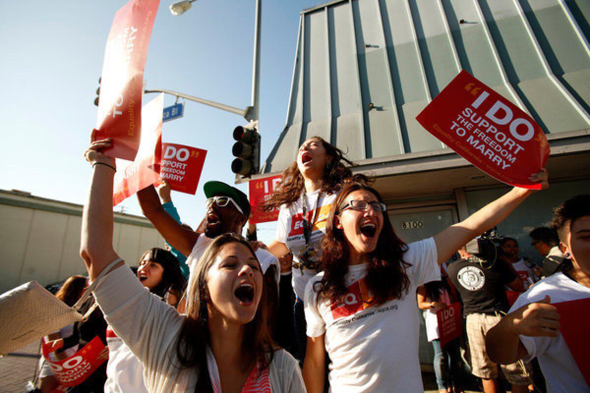 People react outside the Equality California offices in West Hollywood to a ruling by U.S. Supreme Court that the sponsors of California's controversial Proposition 8 did not have the legal standing to appeal a 2010 ruling against the measure, a procedural act that cleared the way for same-sex marriage in California but avoided a nationwide decision.