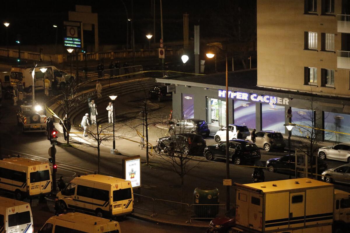 Police investigate the scene of the Jan. 9 terror siege at a kosher market near the Porte de Vincennes, where four hostages were killed before police stormed the scene and shot the attacker dead.