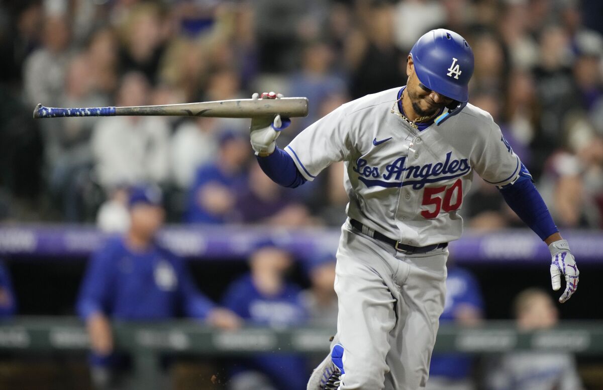 Dodgers right fielder Mookie Betts tosses his bat after connecting for an RBI single.