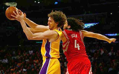 Defusing a Rocket: Pau receives a pass while being defended by Luis Scola of the Houston Rockets during an April 3 game.