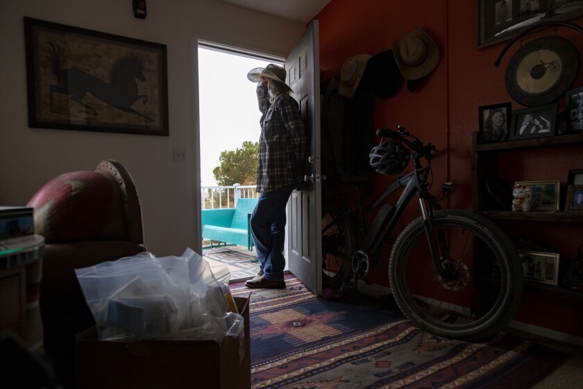 Column: A cancer patient needed critical care. Because of
the COVID-19 surge, she died without it 1 Billy Folsom looks out an open door