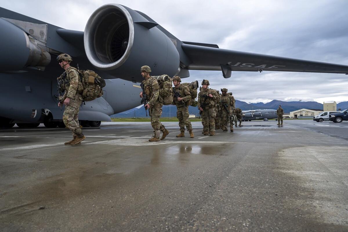 U.S. Army Soldiers board a U.S. Air Force C-17.