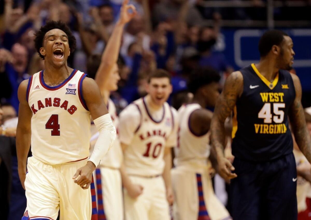 Kansas guard Devonte' Graham (4) celebrates after making a three-pointer late in the game against the West Virginia Mountaineers on Feb. 13.