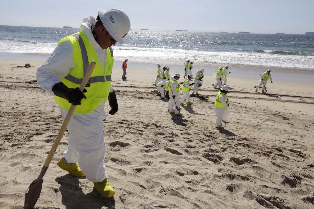  Workers continue cleaning Huntington Beach.