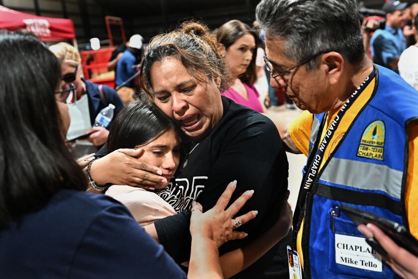 Uvalde, Texas May 25, 2022- A fourth grade teacher at Robb Elementary school consoles her student after a vigil at the Uvalde County Fairplex in Texas Wednesday. The teacher who did not give her name said "I told my students to get down and pray" after she heard the gun fire. (Wally Skalij/Los Angeles Times)