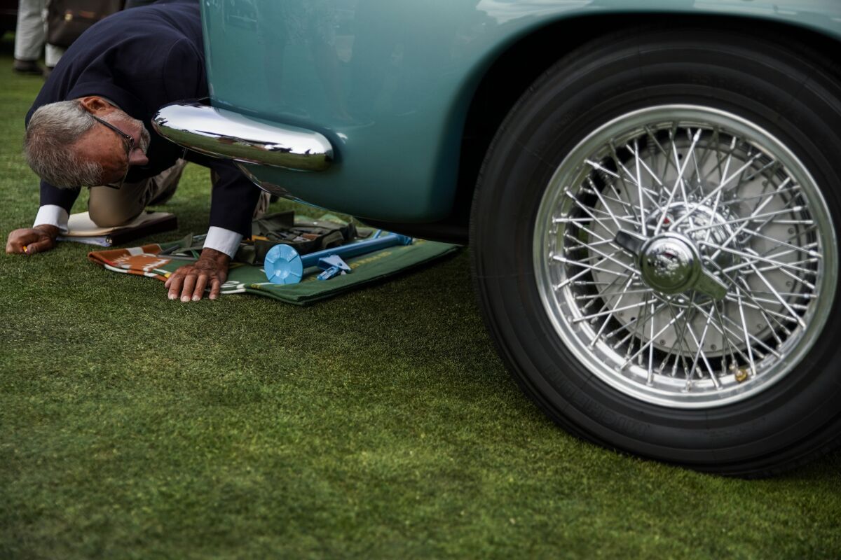  Judge Ron Hein inspects a car at the 69th Pebble Beach Concours d'Elegance