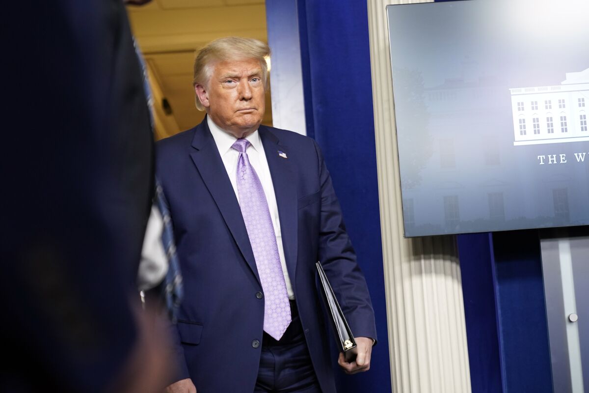 President Trump arrives to speak at a news conference at the White House, Thursday, Aug. 13, 2020