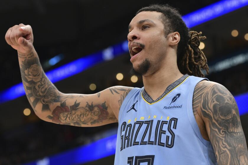 A Memphis Grizzlies player lifts his fist and yells