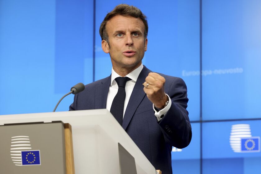 FILE - French President Emmanuel Macron addresses a media conference at an EU summit in Brussels, Thursday, June 23, 2022. Leaders from around Europe are converging on the Czech capital Prague to launch a new “European Political Community.” The aim, the European Union says, is to boost security and economic prosperity across the continent. But critics claim the new forum is an attempt to put the brakes on EU enlargement, by creating a waiting room for want-to-be members. (AP Photo/Olivier Matthys, File)