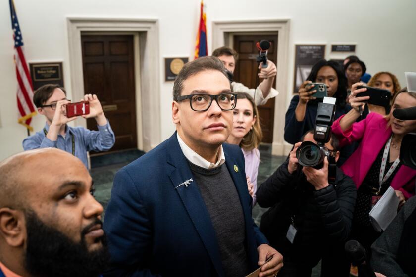 WASHINGTON, DC - JANUARY 31: Reporters surround embattled Rep. George Santos (R-NY) as he heads to the House Chamber for a vote, at the U.S. Capitol on Tuesday, Jan. 31, 2023 in Washington, DC. (Kent Nishimura / Los Angeles Times)