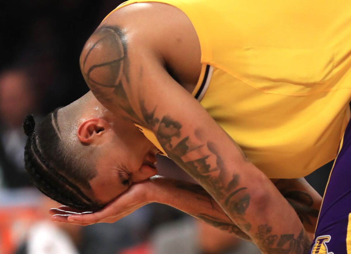 Lakers forward Kyle Kuzma winces in pain after suffering an eye injury.