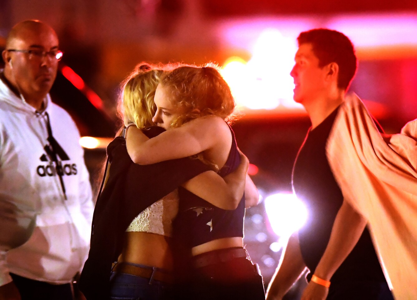 People comfort each other after a mass shooting at the Borderline Bar & Grill in Thousand Oaks late Wednesday night.
