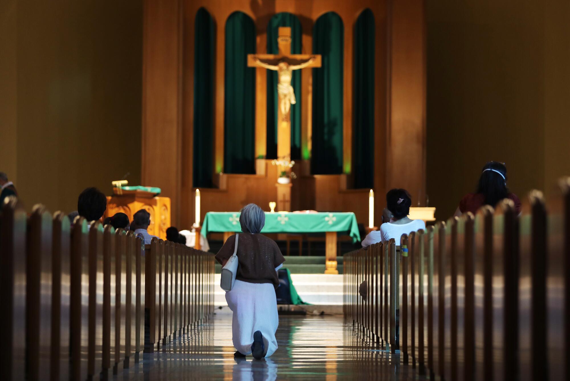 Parishioners attend mass at San Gabriel Mission Church in San Gabriel on Sunday.