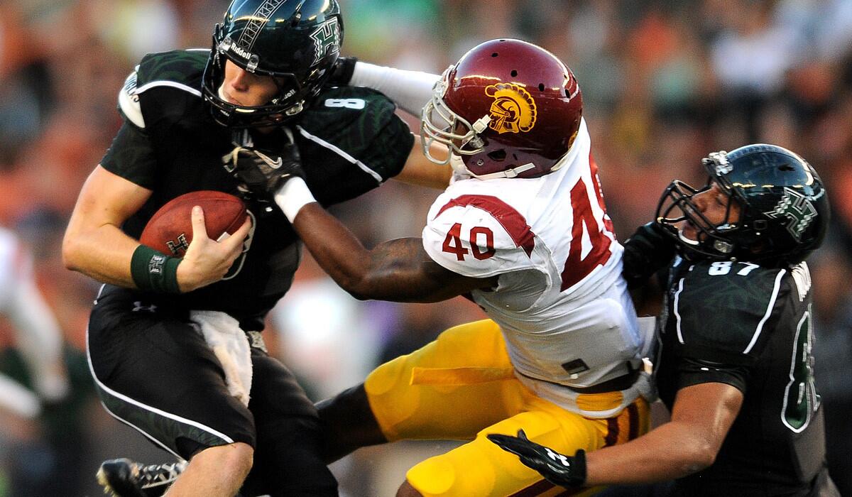 USC linebacker Jabari Ruffin tries to bring down Hawaii quarterback Taylor Graham during a game last season at Aloha Stadium.