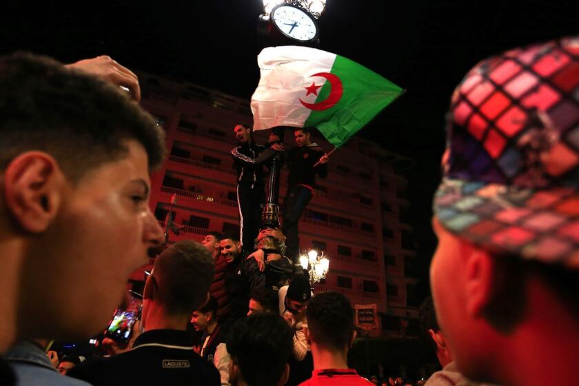 Algerian people, waving their national flag, celebrate in the streets of Algiers after President Abdelaziz Bouteflika announced that he is delaying the April 18 election and won't seek another term, Monday, March 11, 2019. Bouteflika bowed to unprecedented public protests Monday and promised not to seek a fifth term after 20 years in power. (AP Photo/Toufik Doudou)