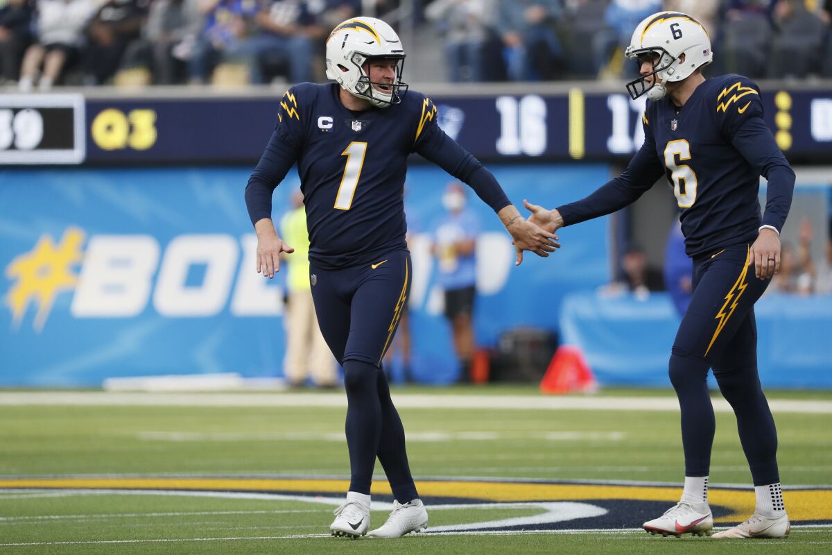 Chargers punter/holder Ty Long (1) congratulates kicker Dustin Hopkins after his 48-yard field goal against the Patriots.