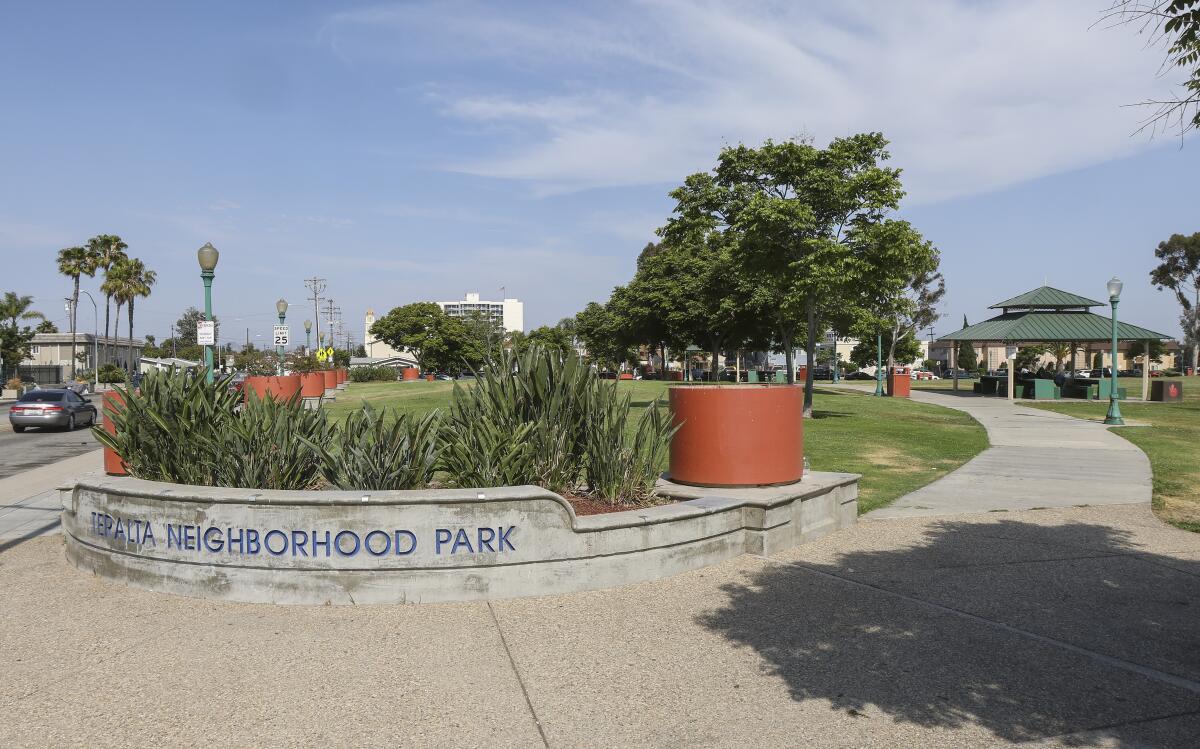 Teralta Neighborhood Park has sidewalks, trees, plants, grass and a covered area with seating