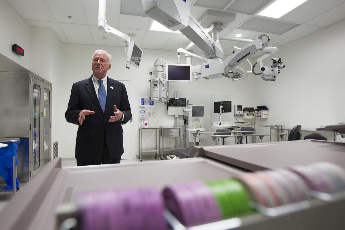 Dr. Roger Steinert, the director of the Gavin Herbert Eye Institute, gives a tour of one of two operating rooms during the grand opening of the facility on Wednesday, September 11.